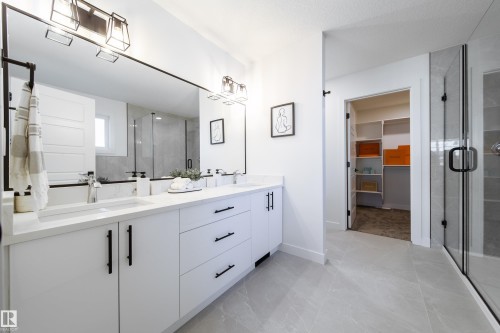 Bathroom featuring a shower stall, a walk in closet, and double vanity - 33 Sun Meadows Cl, Stony Plain, AB - Indoor Photo Showing Bathroom