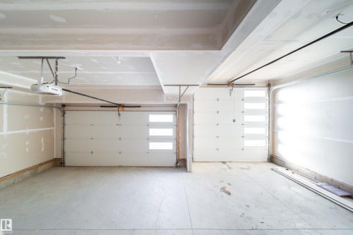 Garage featuring a garage door opener - 33 Sun Meadows Cl, Stony Plain, AB - Indoor Photo Showing Garage