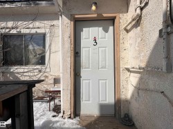 Entry door with panel details and a prominent numerical marker - 