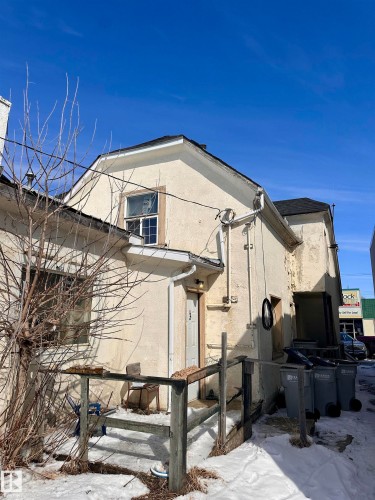 Stucco exterior featuring a gabled roofline and multiple windows - 10528 100 Avenue, Westlock, AB - Outdoor