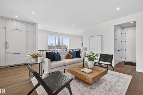 Bright living area featuring wood-finish flooring and a neutral color palette - 149 Eastgate Way, St. Albert, AB - Indoor Photo Showing Living Room