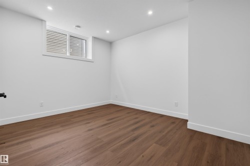 Spacious room featuring wood-finish flooring, white baseboards, and clean white walls - 149 Eastgate Way, St. Albert, AB - Indoor Photo Showing Other Room
