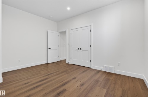 Spacious room featuring wood-finish flooring, white walls, and bright overhead lighting - 149 Eastgate Way, St. Albert, AB - Indoor Photo Showing Other Room