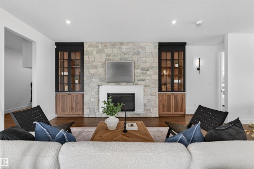 Stone-clad fireplace with a white mantel and black firebox - 149 Eastgate Way, St. Albert, AB - Indoor Photo Showing Living Room With Fireplace