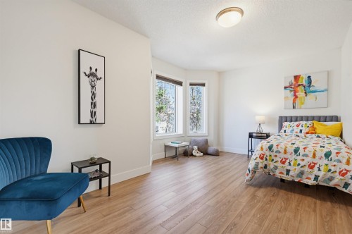 Spacious interior room featuring light wood-finish flooring and white walls - 11539 75 Avenue, Edmonton, AB - Indoor Photo Showing Bedroom