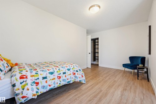 Spacious room featuring wood-finish flooring and a neutral color palette - 11539 75 Avenue, Edmonton, AB - Indoor Photo Showing Bedroom