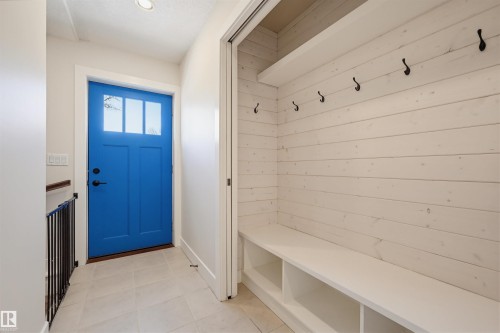 Entryway featuring a vibrant blue front door with transom windows, recessed lighting, and tile flooring - 11539 75 Avenue, Edmonton, AB - Indoor Photo Showing Other Room