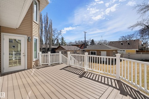 Spacious outdoor deck featuring composite decking and white railings - 11539 75 Avenue, Edmonton, AB - Outdoor With Exterior