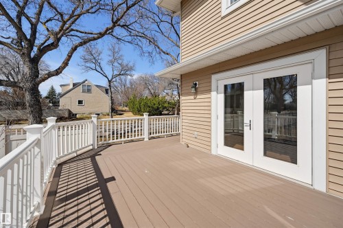 Expansive outdoor deck featuring wood-finish flooring and white railing - 11539 75 Avenue, Edmonton, AB - Outdoor With Exterior