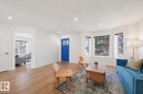 Living area featuring wood-finish flooring, recessed lighting, and a bright blue front door - 11539 75 Avenue, Edmonton, AB  - Indoor Photo Showing Living Room 