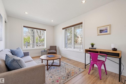 Bright room featuring light wood-finish flooring, white walls, and recessed lighting - 11539 75 Avenue, Edmonton, AB - Indoor Photo Showing Living Room