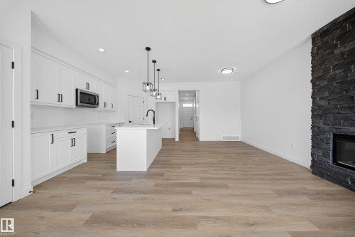 227 Deer Valley Drive, Leduc, AB - Indoor Photo Showing Kitchen With Fireplace