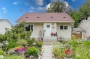 Property exterior featuring a light-colored stucco finish, a reddish-brown shingled roof, a white front door, and a stone walkway - 12026 104 Street, Edmonton, AB  - Outdoor 