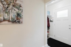 White entry door featuring an upper window panel and chrome hardware - 