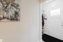 White entry door featuring an upper window panel and chrome hardware - 12026 104 Street, Edmonton, AB  - Indoor Photo Showing Other Room 
