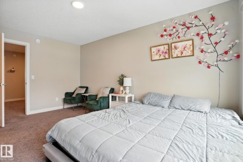 The room features neutral-toned walls and carpeted flooring, providing a versatile backdrop - 6260 175 Avenue, Edmonton, AB - Indoor Photo Showing Bedroom