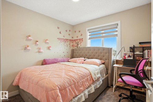 This room features a window providing natural light, neutral-toned walls, and carpeted flooring - 6260 175 Avenue, Edmonton, AB - Indoor Photo Showing Bedroom