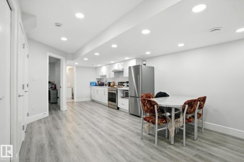 The open-plan living area features light-toned flooring, recessed lighting, and white walls - 6260 175 Avenue, Edmonton, AB - Indoor