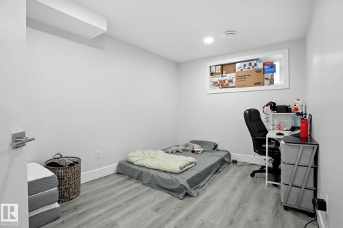 This room features light grey walls, recessed lighting, and light-colored wood-look flooring - 6260 175 Avenue, Edmonton, AB - Indoor