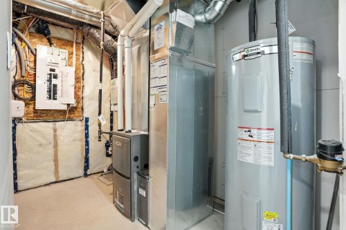 Well-maintained utility area featuring an electrical panel, water heater, and furnace - 6260 175 Avenue, Edmonton, AB - Indoor Photo Showing Basement