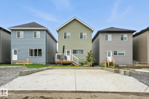 The property features a private deck with white railings, a small tree, and a concrete pad - 6260 175 Avenue, Edmonton, AB - Outdoor