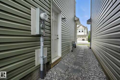 This property features a gravel path with stepping stones leading to an exterior door - 6260 175 Avenue, Edmonton, AB - Outdoor