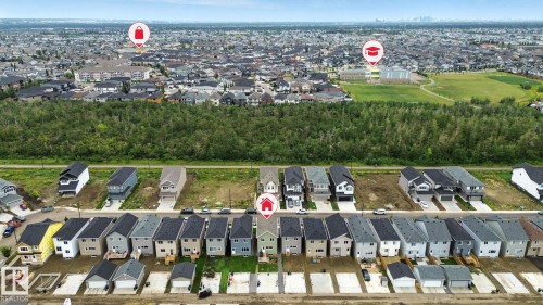 Aerial view of the neighborhood showcasing a row of residential properties with dark roofs and light-colored exteriors - 6260 175 Avenue, Edmonton, AB - Outdoor With View