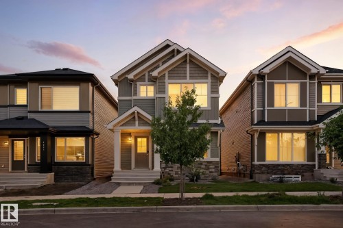 The property features a charming exterior with a gabled roofline and stone accent details - 6260 175 Avenue, Edmonton, AB - Outdoor With Facade