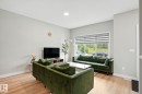 This living area features light-colored walls, recessed lighting, and light wood flooring - 6260 175 Avenue, Edmonton, AB  - Indoor Photo Showing Living Room 