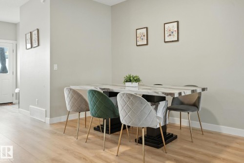 Dining area featuring light-colored flooring and light grey walls - 6260 175 Avenue, Edmonton, AB - Indoor Photo Showing Dining Room