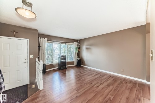 Spacious entryway with wood-finish flooring extending into the main living area - 9845 184 Street, Edmonton, AB - Indoor Photo Showing Other Room