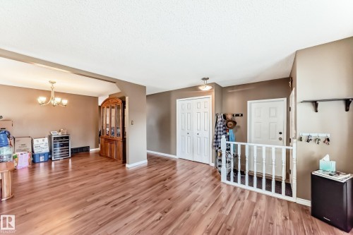 Spacious interior featuring wood-finish flooring, neutral wall tones, and recessed lighting - 9845 184 Street, Edmonton, AB - Indoor Photo Showing Other Room