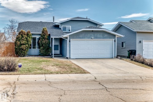Two-story residence featuring light blue siding, an attached two-car garage, and a concrete driveway - 9845 184 Street, Edmonton, AB - Outdoor