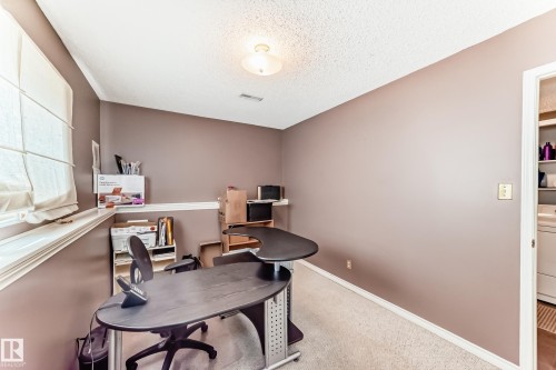 Room featuring light brown walls, textured white ceiling, recessed lighting, and a window with a fabric shade - 9845 184 Street, Edmonton, AB - Indoor Photo Showing Office