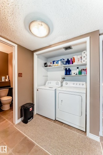 Dedicated laundry area featuring a white washing machine and dryer - 9845 184 Street, Edmonton, AB - Indoor Photo Showing Laundry Room