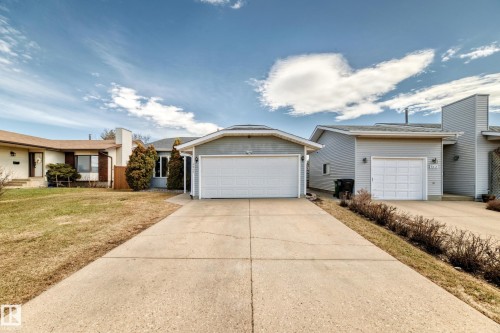 Gray single-story residence featuring a two-car garage, concrete driveway, and light blue siding - 9845 184 Street, Edmonton, AB - Outdoor With Facade