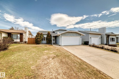 Light blue siding exterior with a single-car garage and concrete driveway - 9845 184 Street, Edmonton, AB - Outdoor With Facade