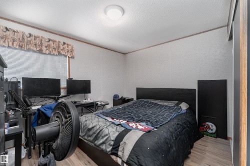 This room features light-colored walls and wood-look flooring - 1663 Jubilee Crescent, Sherwood Park, AB - Indoor Photo Showing Bedroom