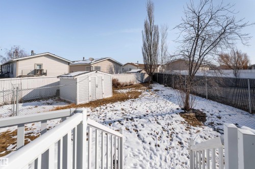 The property features a backyard with a storage shed and a chain link fence - 1663 Jubilee Crescent, Sherwood Park, AB - Outdoor