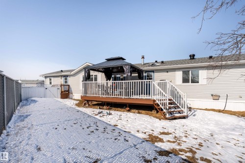 The property features a spacious rear deck with white railings and an outdoor gazebo, offering an inviting area for enjoyment - 1663 Jubilee Crescent, Sherwood Park, AB - Outdoor With Deck Patio Veranda