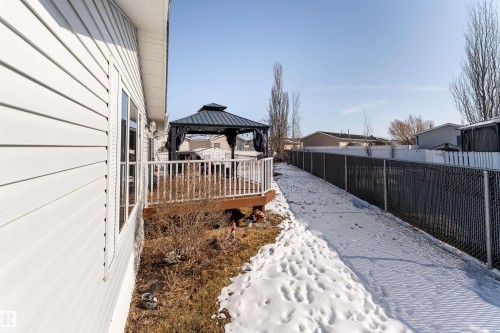 The property features white siding and a deck with a white railing, complete with a dark-colored gazebo - 1663 Jubilee Crescent, Sherwood Park, AB - Outdoor With Deck Patio Veranda