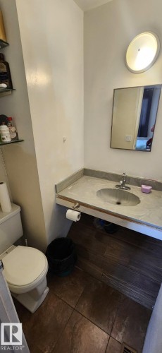 Bathroom featuring a built-in vanity with an oval undermount sink and single-handle faucet - 14411 31 Street, Edmonton, AB - Indoor Photo Showing Bathroom