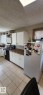 Kitchen featuring white cabinetry, stone-finish countertops, black appliances, and tile flooring - 14411 31 Street, Edmonton, AB  - Indoor Photo Showing Kitchen 