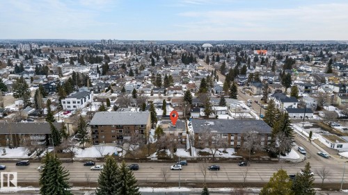 Aerial view showcasing the property situated within a developed urban area with numerous residential structures and mature trees - 2 9140 149 Street, Edmonton, AB - Outdoor With View