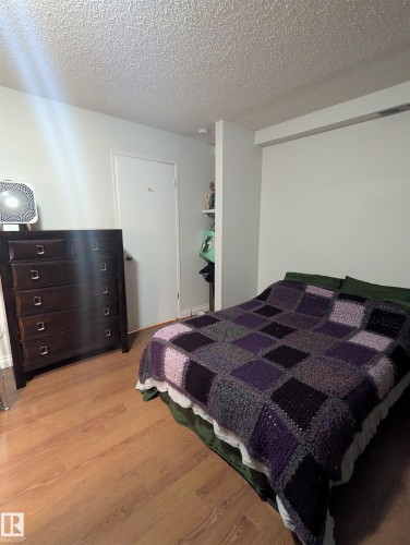 The room features light wood-look flooring and a white ceiling - 2 9140 149 Street, Edmonton, AB - Indoor Photo Showing Bedroom