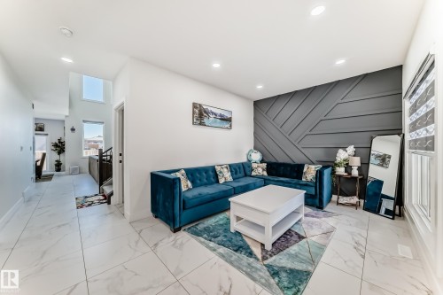 Living area with a distinctive accent wall featuring geometric paneling - 17459 80 Street, Edmonton, AB - Indoor