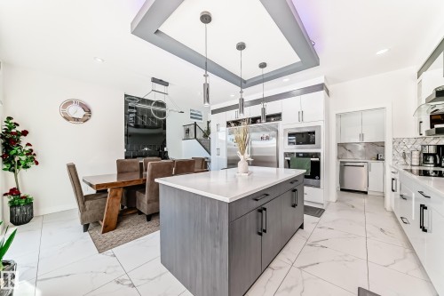 Open-concept kitchen and dining area with white tile flooring throughout - 17459 80 Street, Edmonton, AB - Indoor Photo Showing Kitchen With Upgraded Kitchen