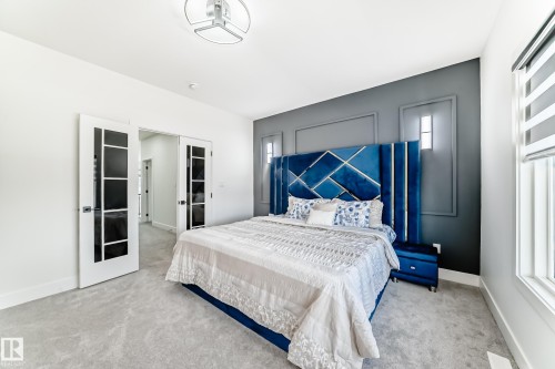 Bedroom featuring light gray carpeting and a contrasting accent wall with decorative molding - 17459 80 Street, Edmonton, AB - Indoor Photo Showing Bedroom