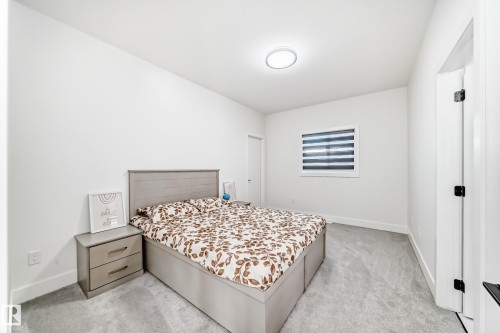 Bedroom featuring light gray carpeting, crisp white walls, a recessed ceiling light fixture, and a window with horizontal blinds - 17459 80 Street, Edmonton, AB - Indoor Photo Showing Bedroom