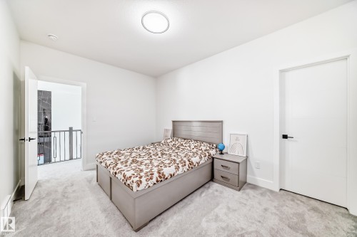 Neutral-toned bedroom featuring light grey carpeting and crisp white walls - 17459 80 Street, Edmonton, AB - Indoor Photo Showing Bedroom
